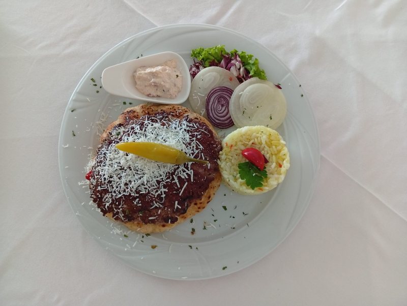 Stuffed pljeskavica — grated cheese, rice, onion & ajvar